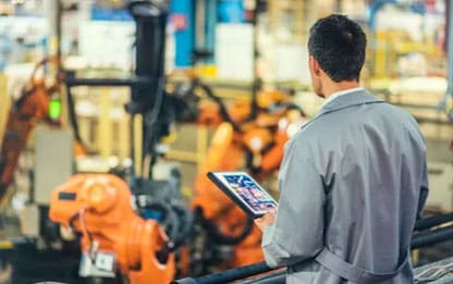 Man with Tablet Overlooking Machinery